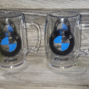 Pair of dated BMW thick plastic mugs