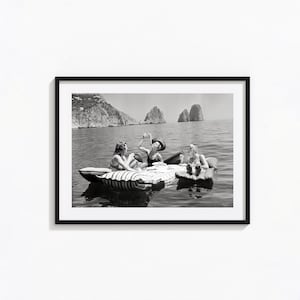 Floating Luncheon, Three young women eat spaghetti on inflatable mattresses at Lake of Capri, Black and White Wall Art, Vintage Print