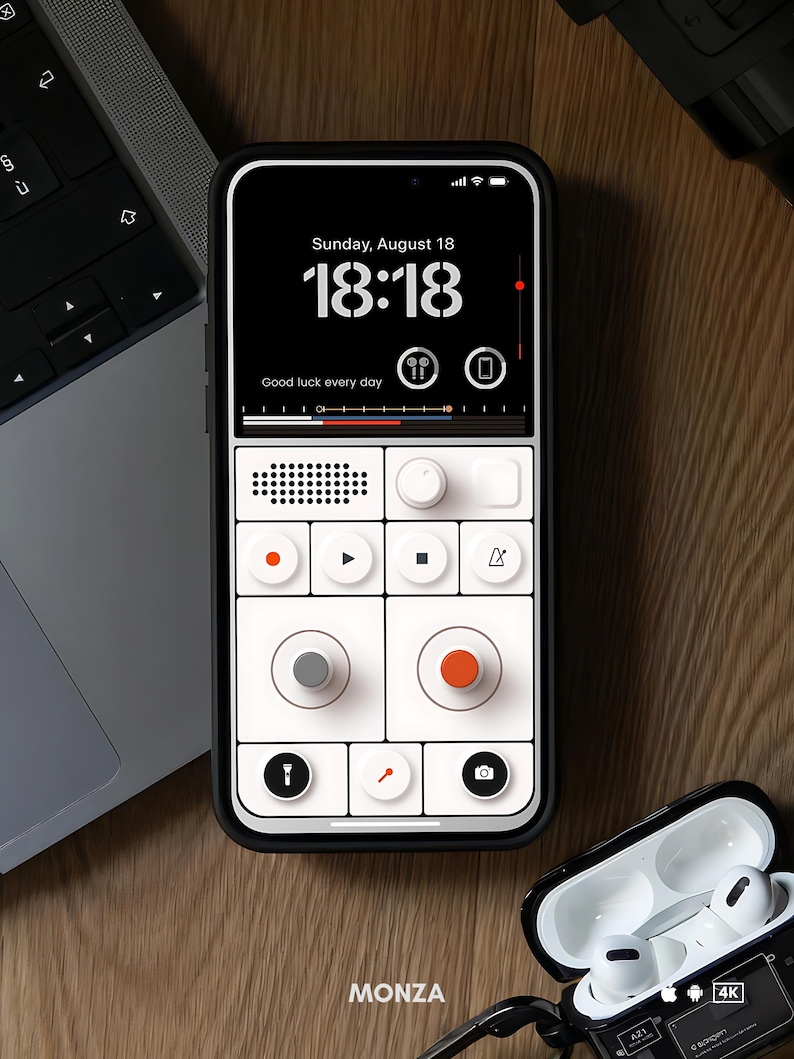 May include: A black smartphone with a white and black interface, displaying the time and the words "Good luck every day." The phone is next to a laptop and a pair of white earbuds in a black case. The brand name "MONZA" is visible.