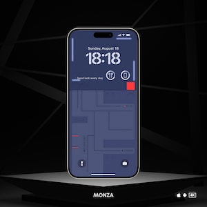 May include: A smartphone displaying a map app with a blue background and red markers. The time is 18:18 and the date is Sunday, August 18. The text "Good luck every day" is displayed on the screen. The phone is on a dark gray surface with the word "MONZA" in white text below it.