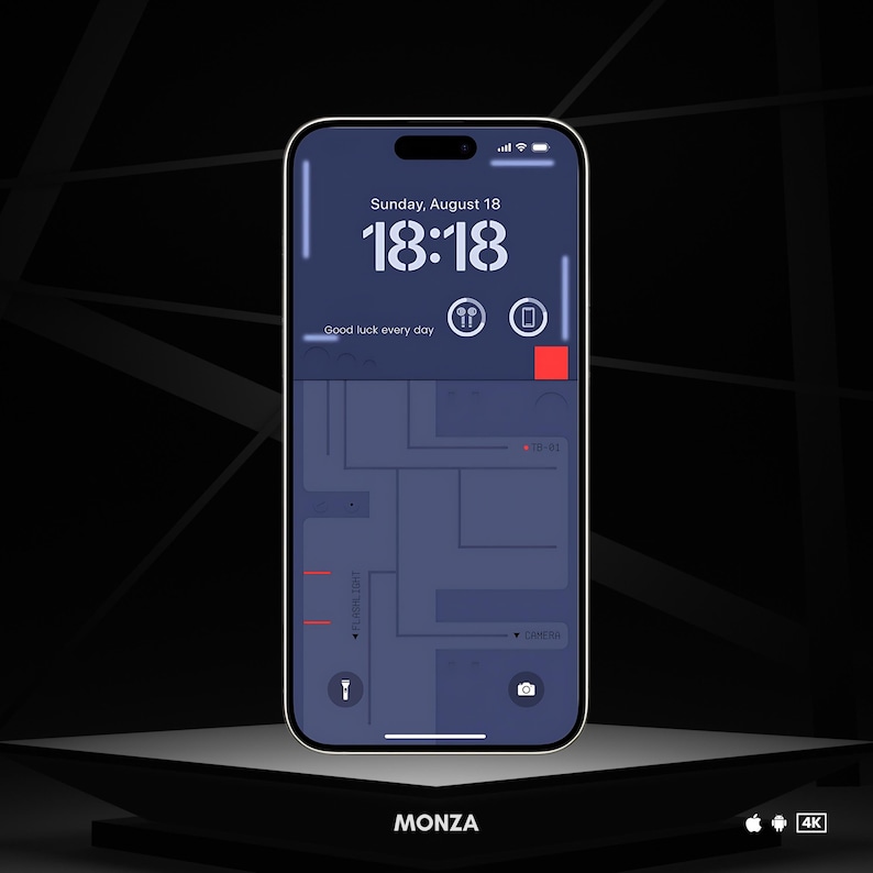 May include: A smartphone displaying a map app with a blue background and red markers. The time is 18:18 and the date is Sunday, August 18. The text "Good luck every day" is displayed on the screen. The phone is on a dark gray surface with the word "MONZA" in white text below it.