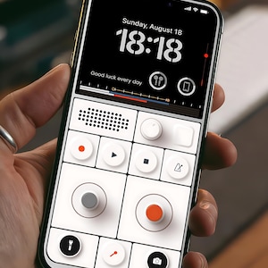 May include: A smartphone with a retro-style interface, featuring a black screen displaying the time, date, and the text "Good luck every day." The phone has a white and black design with various buttons and icons. The word "MONZA" is at the bottom.