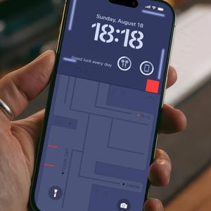 May include: A smartphone displaying a map with the word "MONZA" at the bottom. The time is 18:18 and the date is Sunday, August 18. The phone has a flashlight and camera icon at the bottom.