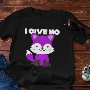 May include: Black t-shirt with a purple cartoon fox wearing black boots and the text "I GIVE NO" in white.