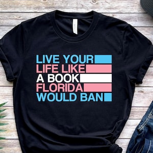 Transgender Pride Unisex T-Shirt, Live Life Like A Florida Banned Book, Discreet LGBTQ Trans Pride Gift, Subtle Ftm Mtf Flag, Funny LGBTQIA