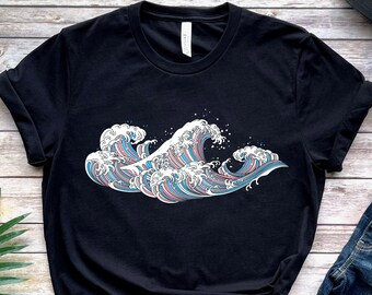 May include: Black t-shirt with a wave design in blue, pink, and white. The shirt is styled with blue jeans and a black baseball cap. The word "BLACK" is printed at the bottom left of the image.
