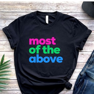 May include: Black t-shirt with the text "most of the above" in pink, green, and blue lettering.