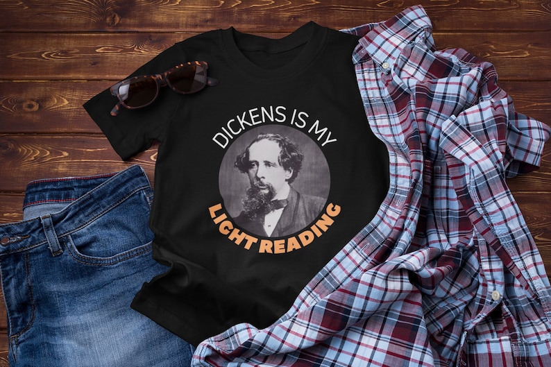 May include: Black t-shirt with a white circle containing a portrait of Charles Dickens and the text "Dickens is my light reading".