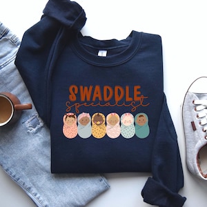 Swaddle Specialist Sweatshirt, Nurse Sweatshirt, Labor and Delivery Sweatshirt, NICU Nurse Shirt, Mother Baby Unit Crewneck, Nursery Hoodies