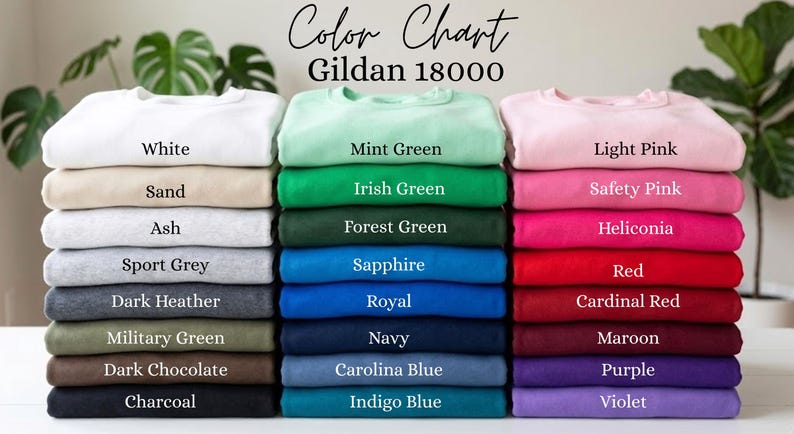 K&ouml;nnte beinhalten: Eine Farbkarte f&uuml;r Gildan 18000 Sweatshirts mit drei vertikalen Stapeln gefalteter Kleidungsst&uuml;cke in verschiedenen Farben. Der Text lautet Color Chart Gildan 18000, mit Beschriftungen f&uuml;r jede Farbe, darunter White, Sand, Ash, Sport Grey, Dark Heather, Military Green, Dark Chocolate, Charcoal, Mint Green, Irish Green, Forest Green, Sapphire, Royal, Navy, Carolina Blue, Indigo Blue, Light Pink, Safety Pink, Heliconia, Red, Cardinal Red, Maroon, Purple und Violet.