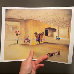 May include: A rectangular art print featuring a surreal yellow room with a grid ceiling. A red-headed figure stands near a doorway, a large brown butterfly-like creature is in the centre, and two wooden chairs are scattered on the floor.