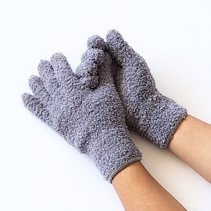 May include: A pair of gray terry cloth gloves with a soft, fuzzy texture. The gloves are worn on both hands and are shown against a white background.