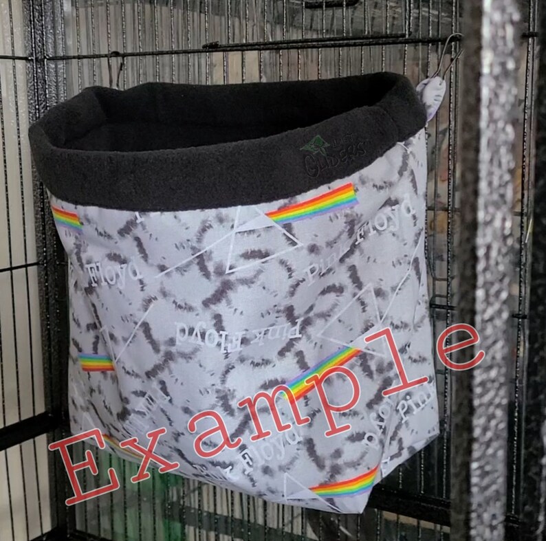 May include: A gray and black hanging bird hammock with a rainbow stripe and the text "Pink Floyd" repeated on the fabric.