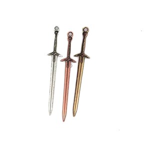 May include: Three miniature swords in different metal finishes: silver, copper, and gold. The swords have intricate details and are perfect for crafting or jewelry making.