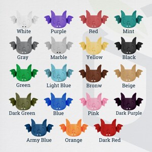 May include: A collection of 16 bat-shaped silicone molds in various colors, including white, purple, red, mint, gray, marble, yellow, black, green, light blue, brown, beige, dark green, blue, pink, dark purple, army blue, orange, and dark red.