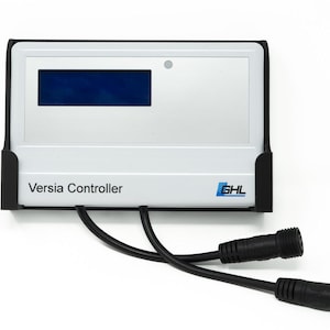May include: A white Versia Controller with a black frame and two black cables with connectors. The controller has a blue display screen and the text "Versia Controller" printed on the front. The GHL logo is visible on the bottom right.
