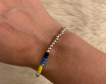 Beaded Bracelet to help victims of War in Ukraine, proceeds donated to CARE to benefit Ukrainian refugees, blue and gold beaded bracelet