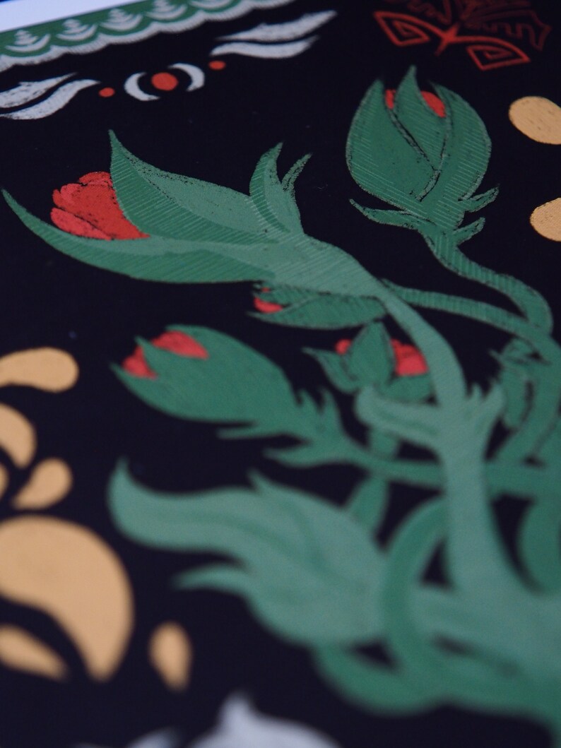 May include: Close-up of a floral design with green leaves and red flower buds against a black background. The design also includes white, yellow, and red decorative elements. The image has a textured, hand-painted appearance.