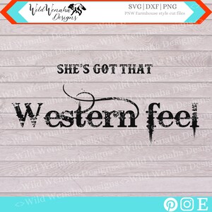 May include: Black and white distressed text graphic design with the words "She's Got That Western Feel" on a woodgrain background.