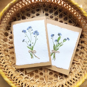 card with real pressed forget me nots on handmade paper