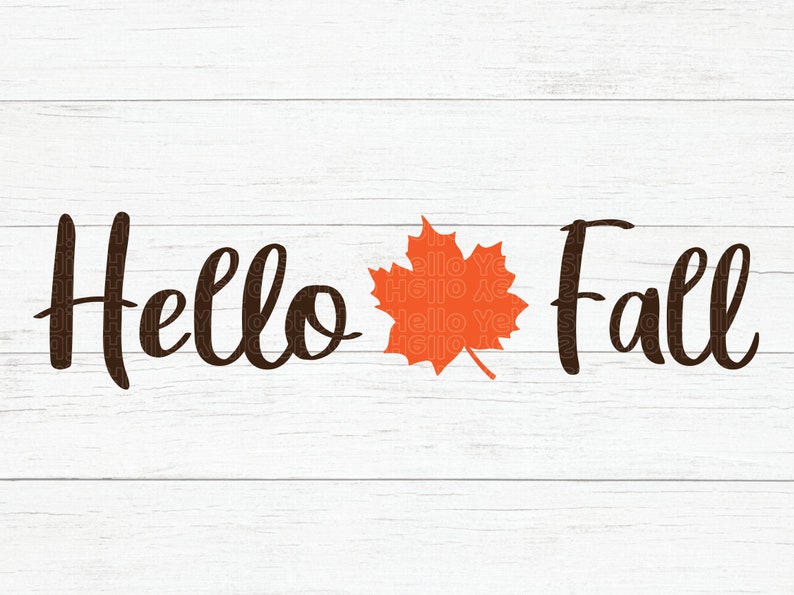 May include: A white wood background with the text "Hello Fall" in black cursive font. An orange maple leaf is centered between the words.