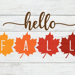 May include: A white wooden background with the text "hello fall" in brown cursive script. Four orange, red, and yellow maple leaves spell out the word "fall" in white letters.