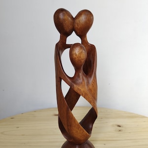 Hand crafted wood family  statue” happy family”
