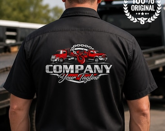 May include: A black short-sleeved button-down shirt featuring a graphic on the back. The design displays two red tow trucks connected by a silver chain and hook, with the text COMPANY and Your Tagline printed in a bold, metallic font.
