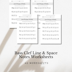 May include: A stack of white worksheets for music students. Each sheet has a title "Name the Bass Clef Notes" and musical notation. The bottom of the image reads "Bass Clef Line & Space Notes Worksheets" and "40 WORKSHEETS".