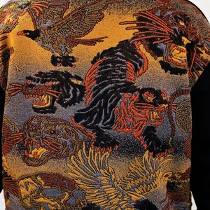 May include: A black sweater featuring a colourful pattern of tigers, birds, and skulls. The design is woven into the fabric and has a vintage feel.