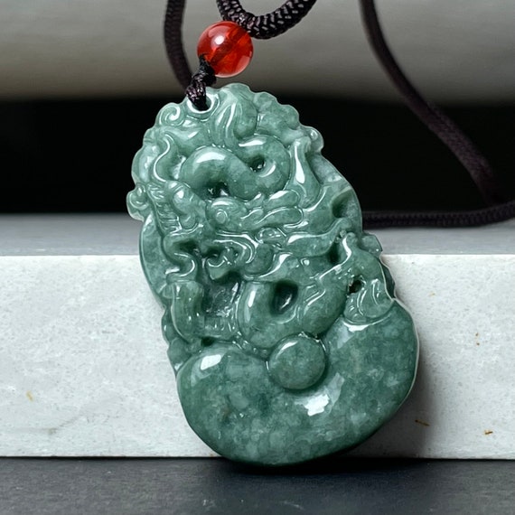 Carved jade dragon pendant clearance