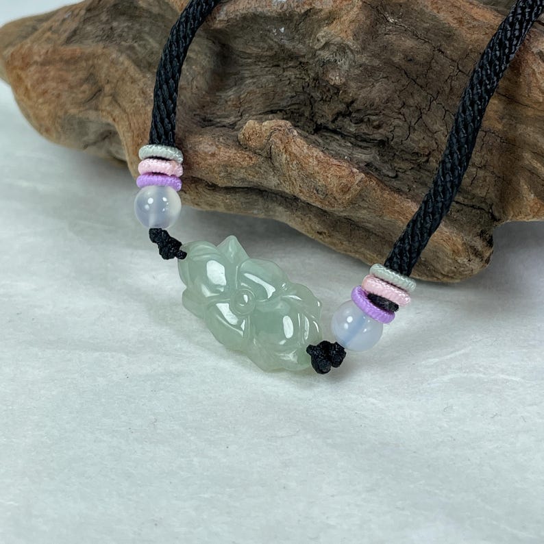 icy green jade bracelet, lotus flower pattern shown on the both side of jade.  top quality jadeite jewelry