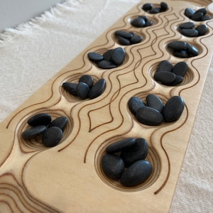 Mancala Board with Black Stones