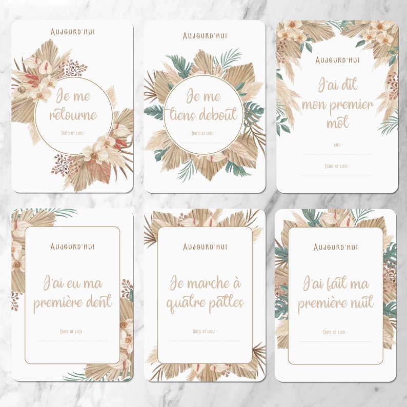 May include: Six printable cards with a neutral color scheme featuring illustrations of pampas grass and flowers. Each card has a different milestone message in French. The messages are 'Je me retourne', 'Je me tiens debout', 'J'ai dit mon premier mot', 'J'ai eu ma premiere dent', 'Je marche a quatre pattes', and 'J'ai fait ma premiere nuit'.