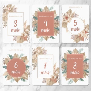 May include: Eight printable cards with a boho theme. Each card has a different number from 3 to 8 with the word 'mois' (French for 'months') below it. The cards are decorated with beige, brown, and green leaves and flowers. The text on the cards reads: 'Aujourd'hui j'ai' (French for 'Today I am').
