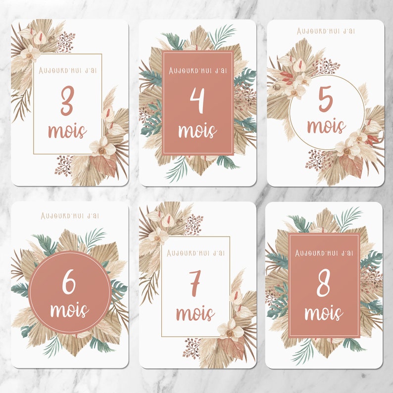 May include: Eight printable cards with a boho theme. Each card has a different number from 3 to 8 with the word 'mois' (French for 'months') below it. The cards are decorated with beige, brown, and green leaves and flowers. The text on the cards reads: 'Aujourd'hui j'ai' (French for 'Today I am').