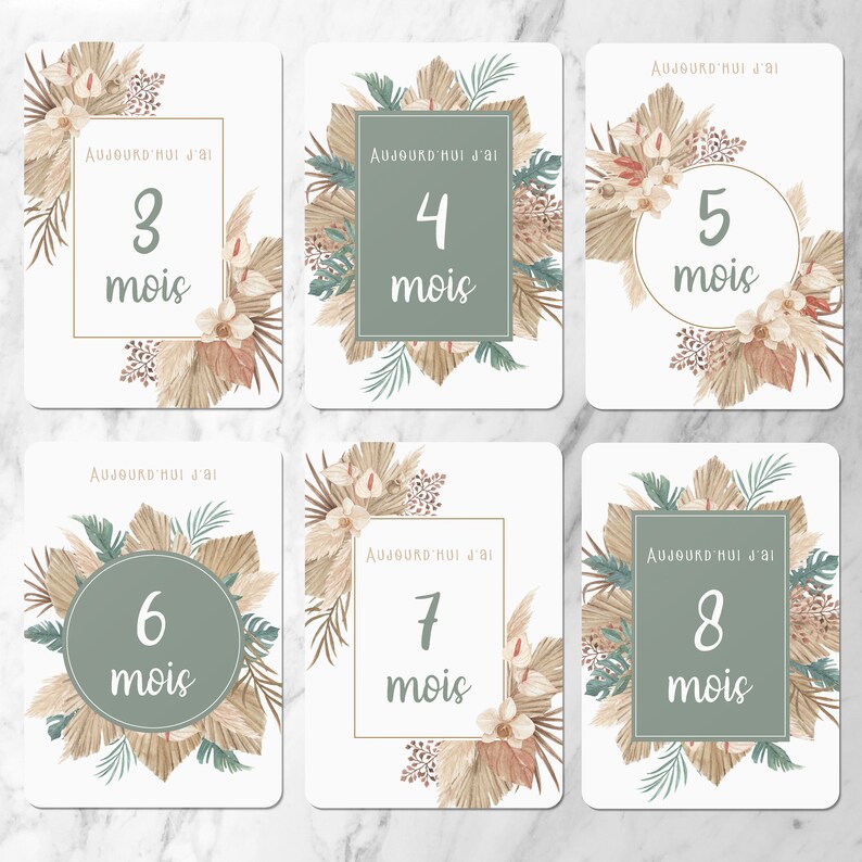 May include: Eight printable cards with a boho theme. Each card has a different number from 3 to 8 with the words 'Aujourd'hui j'ai' and 'mois' (meaning 'Today I am' and 'months' in French). The cards feature a neutral color palette with beige, brown, and green tones. The cards are decorated with palm leaves, dried flowers, and other natural elements.