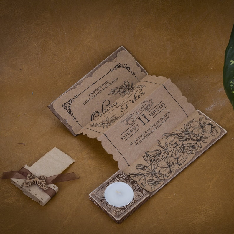 May include: A rustic brown save the date card with a floral design and the text "Olivia and Peter, Save the Date, Saturday II February, At 4 o'clock in the afternoon at Sunflower Restaurant".