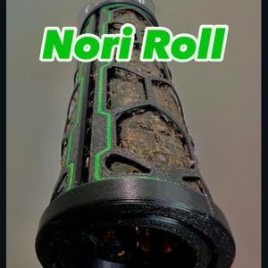 May include: A black and green cylindrical object with the text "Nori Roll" printed on it. The object has a textured surface and a green grid pattern.
