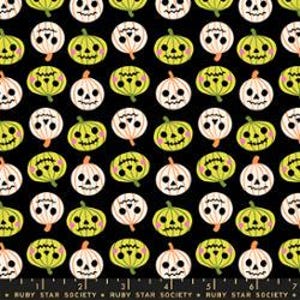 May include: A black fabric featuring a repeating pattern of stylized jack-o'-lanterns in alternating light green and cream colors. Each pumpkin has a carved face with circular eyes, a stitched mouth, and pink cheeks. The text RUBY STAR SOCIETY is printed along the bottom edge.