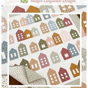May include: A quilt pattern featuring a row of colorful houses with white windows and stars. The quilt is made with a variety of floral fabrics. The pattern is called "Around the Block" and is available from The Pattern Basket.