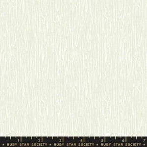 May include: White fabric with a subtle, light green woodgrain pattern. The fabric is textured and has a slightly raised surface. The fabric is perfect for quilting, sewing, and crafting.