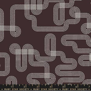 May include: A fabric with a repeating pattern of white, retro-style lines on a dark brown background. The lines curve and intersect, creating a maze-like design. The fabric has a vintage aesthetic.