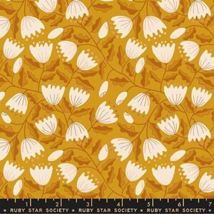 May include: Mustard yellow fabric with a repeating floral pattern. White, bell-shaped flowers with brown stems and leaves are scattered across the surface. The text "RUBY STAR SOCIETY" is printed along the bottom edge.