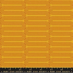 May include: A yellow fabric with a repeating pattern of orange, curved lines. The fabric has a ruler with the text "RUBY STAR SOCIETY" printed on it.