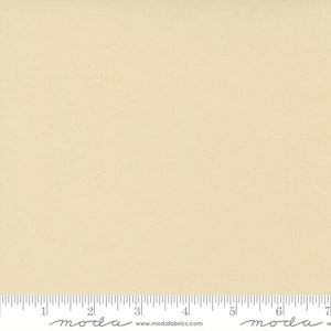 May include: A solid off-white fabric swatch with a subtle texture. The fabric is shown with a ruler measuring 7 inches.