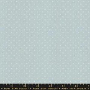 May include: A light blue fabric with a repeating pattern of small white dots. The fabric has a subtle texture and a soft, muted color palette. The bottom of the image shows the text "RUBY STAR SOCIETY".