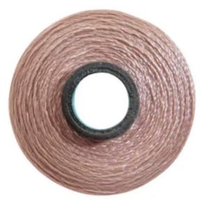 May include: A spool of light pink thread wound around a black and blue plastic bobbin.
