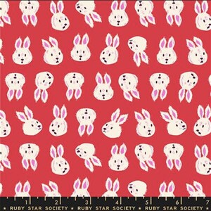 May include: Red fabric with a repeating pattern of white bunny faces with pink ears. The bunnies are in various orientations. The text "RUBY STAR SOCIETY" is at the bottom of the image.