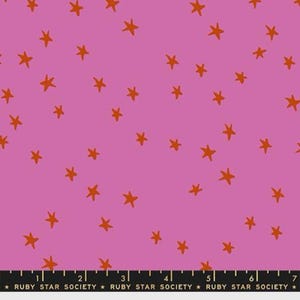 May include: Pink fabric with a pattern of orange stars. The fabric has a ruler along the bottom with the text "RUBY STAR SOCIETY". This fabric is suitable for quilting, sewing, and crafting projects.